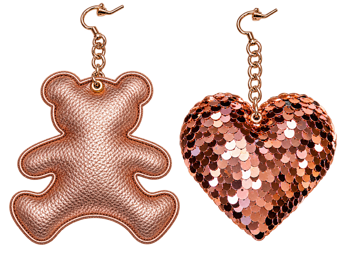 Handmade asymmetric rose gold statement earrings featuring a metallic teddy bear and sparkling sequin heart with rose gold chain details by PAULINA’S FRIENDS.